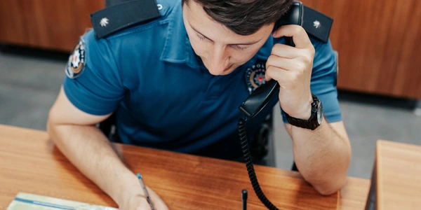 Police officer answering a phone call