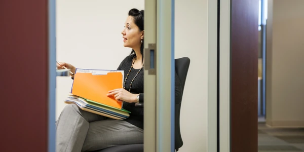 Woman with stack of file folders