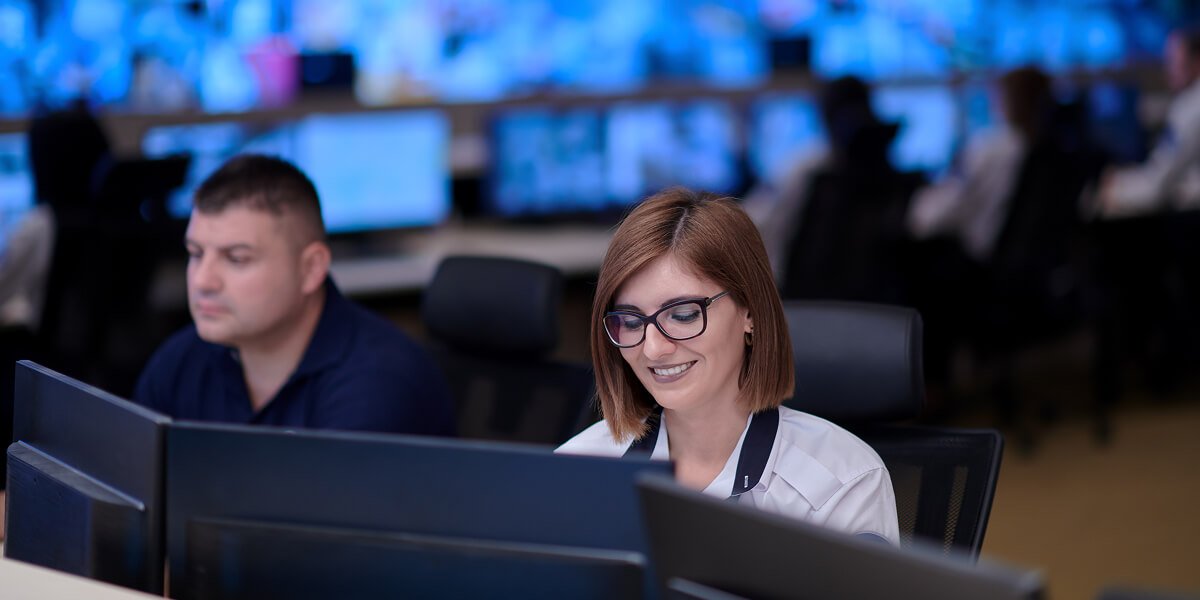Woman working at bank of computers